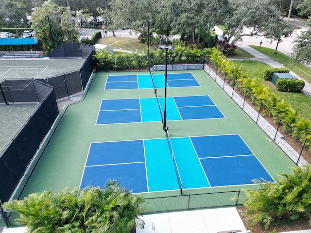 view of tennis court featuring basketball hoop