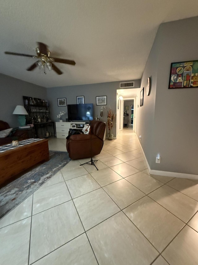 tiled living room with ceiling fan