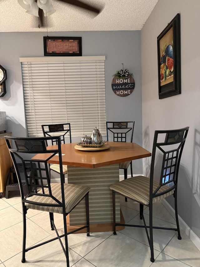 dining room with a textured ceiling and ceiling fan