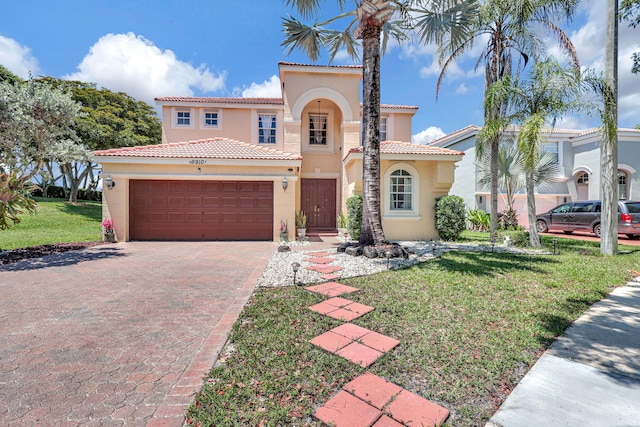 mediterranean / spanish home with a front yard and a garage