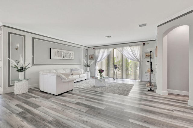 living room with light hardwood / wood-style floors and ornamental molding