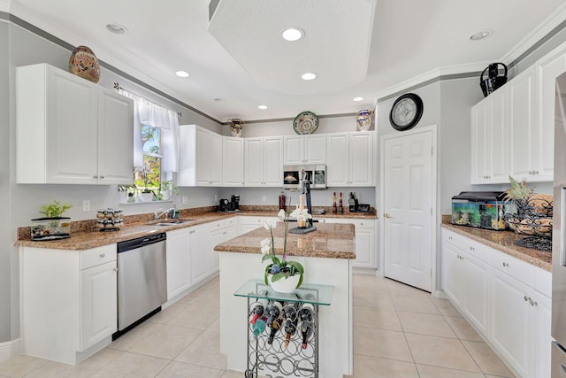 kitchen featuring white cabinetry, stainless steel appliances, and a kitchen island