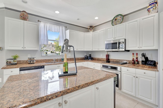 kitchen with crown molding, appliances with stainless steel finishes, and white cabinets