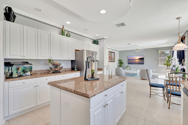 kitchen with white cabinets, hanging light fixtures, and a kitchen island