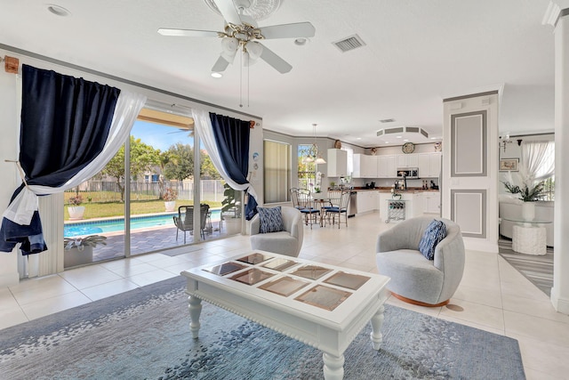 living room featuring ceiling fan and light tile patterned floors