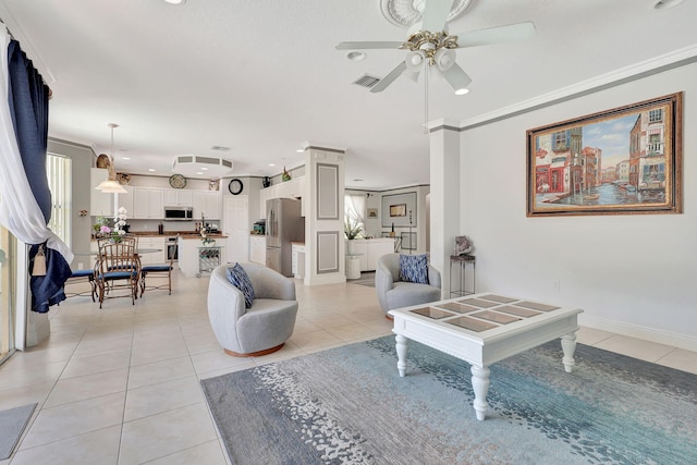 living room featuring crown molding, light tile patterned flooring, and ceiling fan