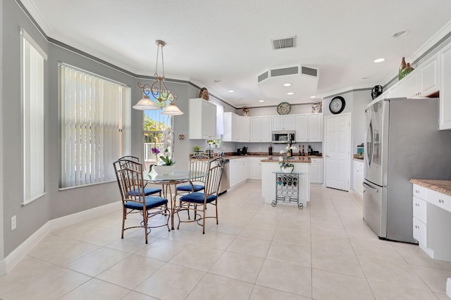 dining room featuring ornamental molding and light tile patterned floors