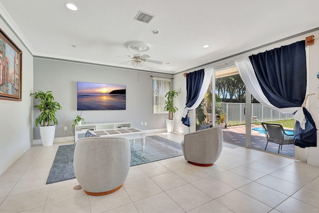 living room with ornamental molding, light tile patterned floors, and ceiling fan