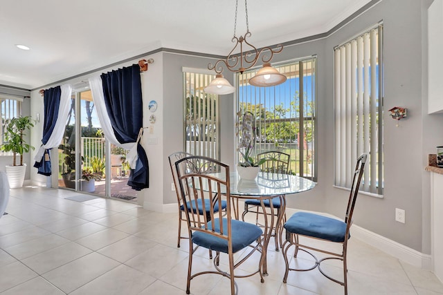 tiled dining area featuring ornamental molding