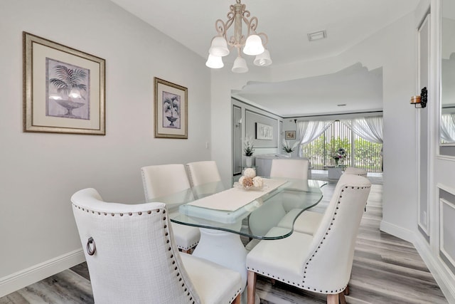 dining area with a notable chandelier and wood-type flooring