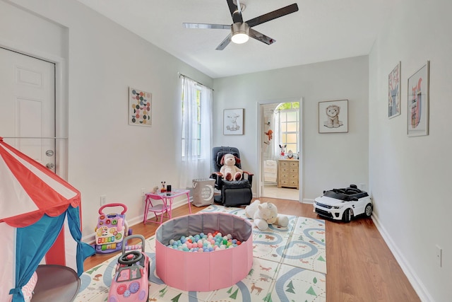 playroom featuring hardwood / wood-style flooring and ceiling fan