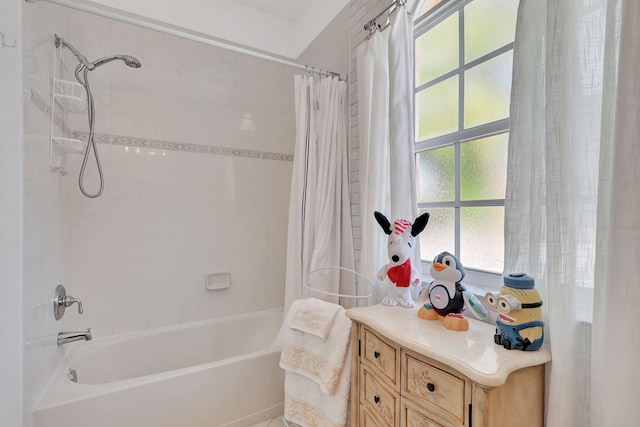 bathroom featuring vanity and shower / tub combo with curtain