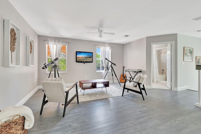 living area featuring hardwood / wood-style floors and ceiling fan