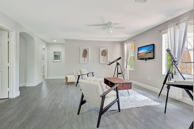 living room featuring hardwood / wood-style floors and ceiling fan