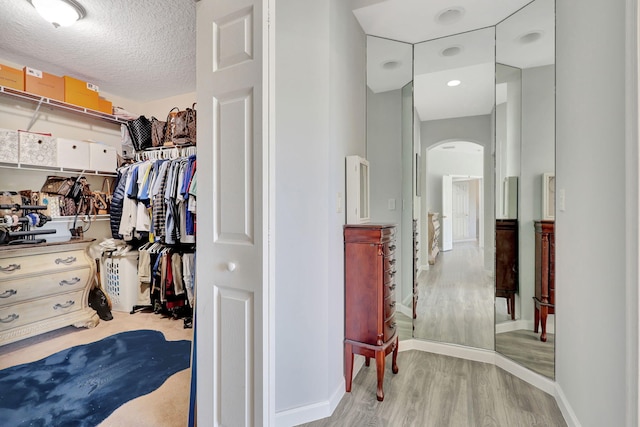 spacious closet featuring light wood-type flooring