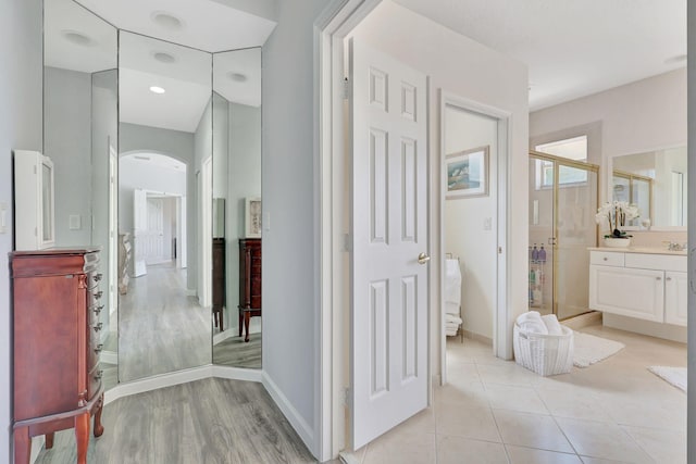 bathroom with vanity, hardwood / wood-style flooring, and walk in shower