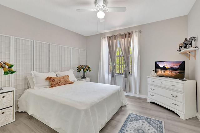 bedroom with ceiling fan and light hardwood / wood-style flooring