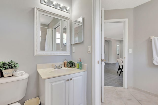 bathroom with vanity, toilet, and hardwood / wood-style flooring