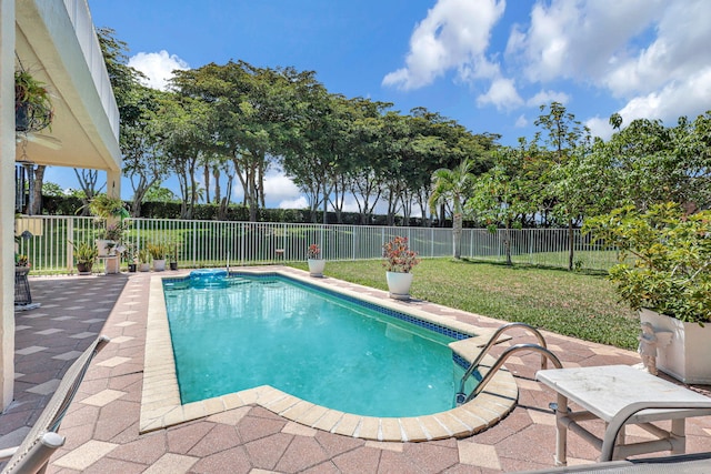 view of swimming pool featuring a yard and a patio area