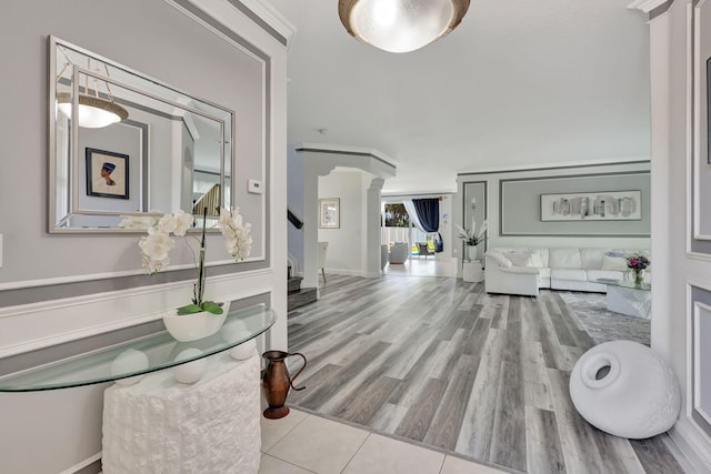 entrance foyer with light hardwood / wood-style flooring and decorative columns