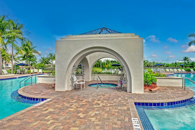 view of pool featuring a community hot tub and a patio