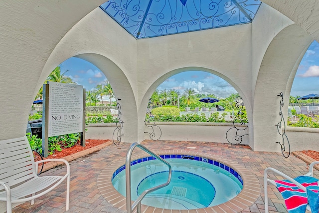 view of pool featuring a patio and a community hot tub