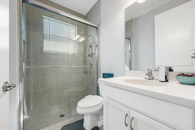 bathroom featuring vanity, toilet, and walk in shower