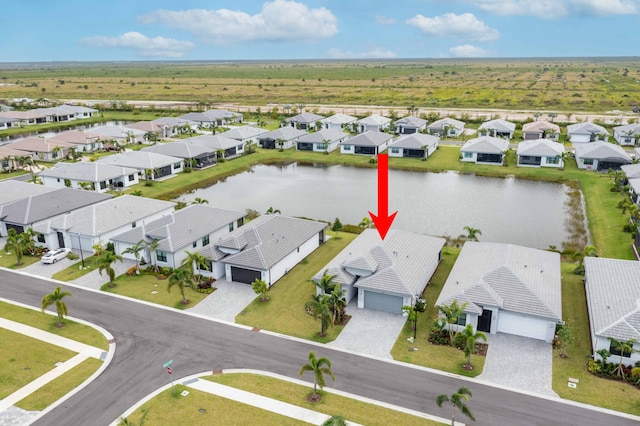 birds eye view of property with a water view and a residential view