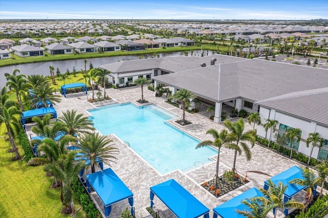 view of pool featuring a patio area and a water view