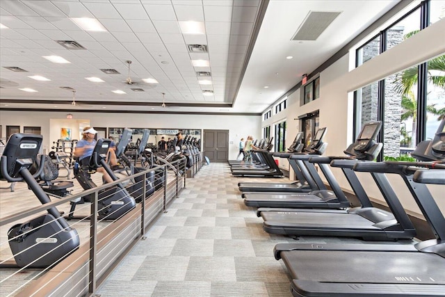 gym featuring a paneled ceiling and light colored carpet