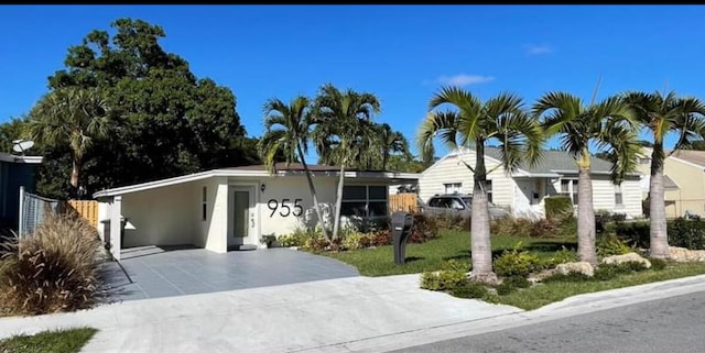 single story home featuring a carport and a front yard