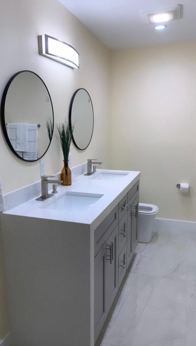 bathroom featuring vanity and toilet