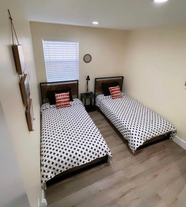 bedroom with hardwood / wood-style flooring