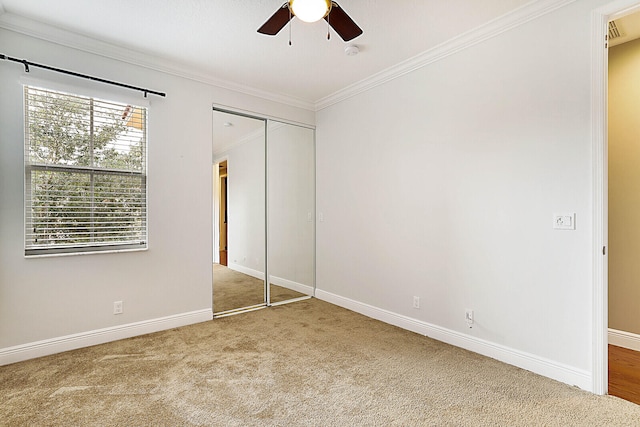 bedroom featuring a raised ceiling, wood-type flooring, ornamental molding, and ceiling fan