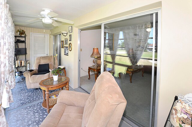 living room featuring ceiling fan and carpet floors