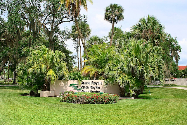 community / neighborhood sign with a lawn