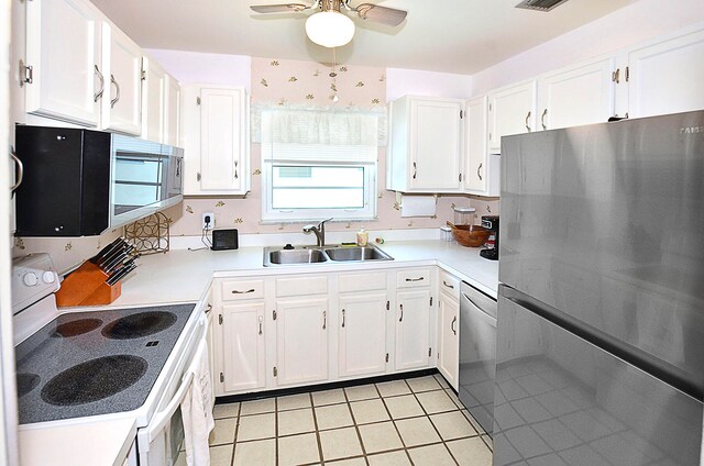 kitchen with sink, white cabinets, stainless steel appliances, light tile patterned floors, and ceiling fan