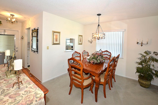 carpeted dining space featuring a textured ceiling and a chandelier