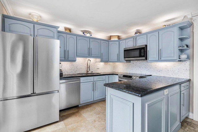 kitchen with sink, blue cabinets, dark stone counters, and appliances with stainless steel finishes