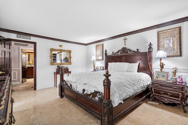 bedroom featuring connected bathroom and crown molding