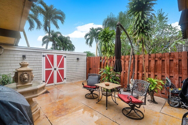 view of patio / terrace with a storage unit