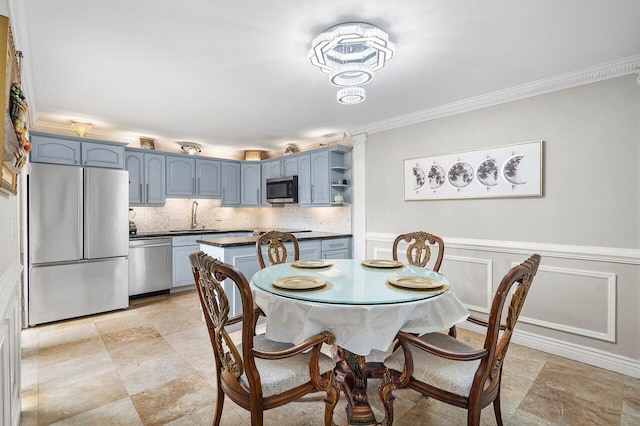 dining room featuring ornamental molding and sink