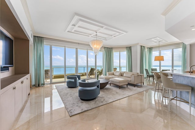 living room with plenty of natural light, a chandelier, a water view, and crown molding