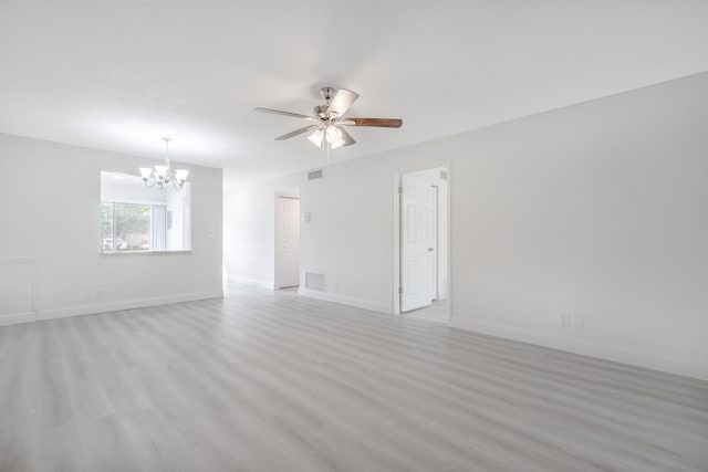 unfurnished room with ceiling fan with notable chandelier and light wood-type flooring