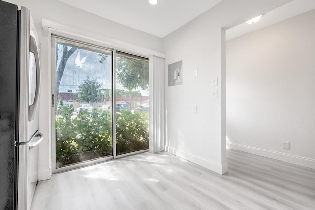 unfurnished room with light wood-type flooring