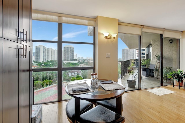 18181 NE 31st Ct Unit 1408, Aventura, FL 33160 - dining area with expansive windows, light wood-style floors, and a view of city