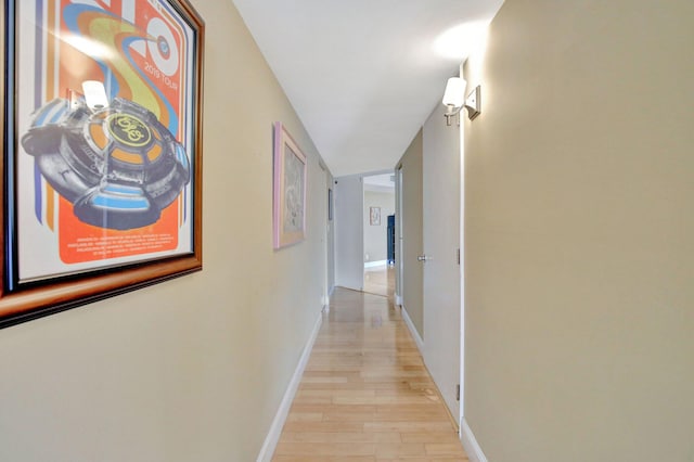 corridor with light hardwood / wood-style floors