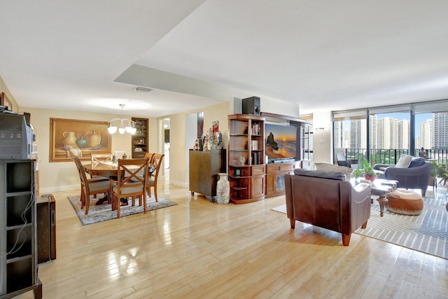 18181 NE 31st Ct Unit 1408, Aventura, FL 33160 - living room with a chandelier, visible vents, light wood finished floors, and baseboards
