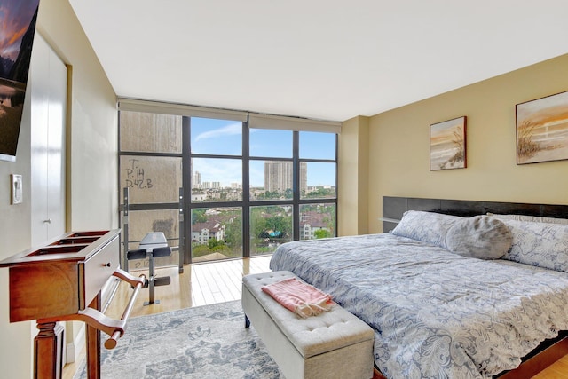 18181 NE 31st Ct Unit 1408, Aventura, FL 33160 - bedroom with expansive windows, wood finished floors, and a view of city