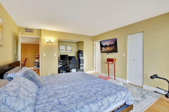 18181 NE 31st Ct Unit 1408, Aventura, FL 33160 - bedroom featuring baseboards, wood finished floors, and visible vents